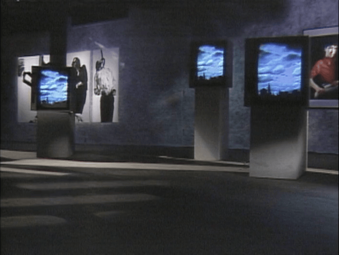 <p>Still from&nbsp;<em>Two Moon July</em>, directed by Tom Bowes,&nbsp;1986. Produced for The Kitchen&nbsp;by Carlota Schoolman. Courtesy of The Kitchen. Shown here: Brian Eno, <em>Mistaken Memories of Mediaeval Manhattan</em>; Robert Longo, <em>Men in the Cities</em>; Cindy Sherman, <em>Untitled</em>.</p>